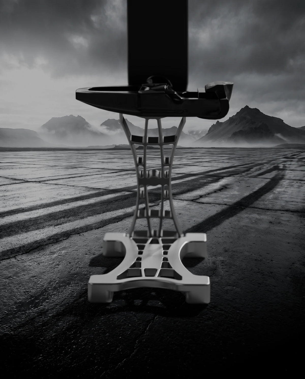 Macro of THE STAND 0.01 under the pedal on wet basalt, machining marks visible