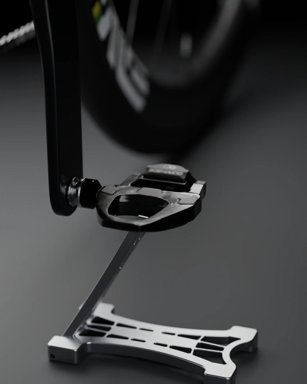 THE STAND 0.01 seen head-on under a road bike pedal, studio background